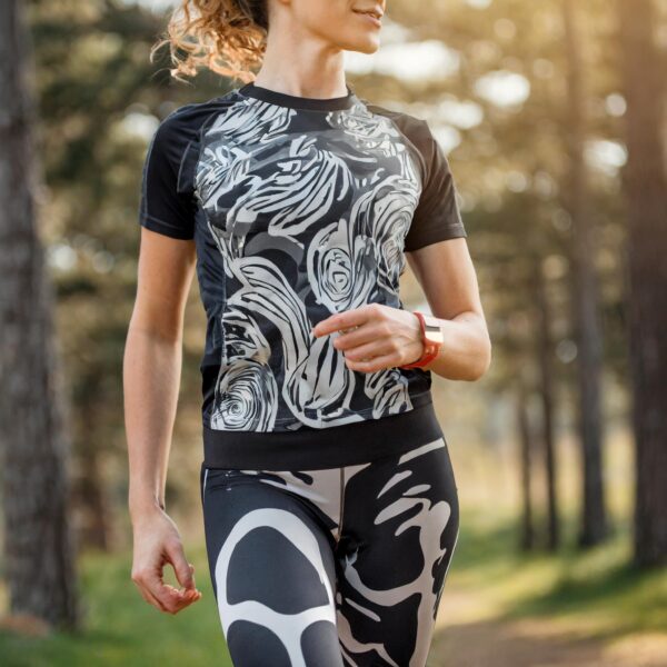 Kvinde løber i skoven i sportsbeklædning.