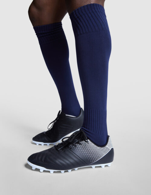 Fodboldspiller med sorte støvler og blå sokker