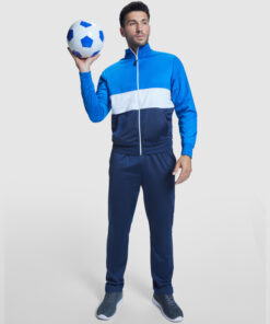 Man in tracksuit holding soccer ball