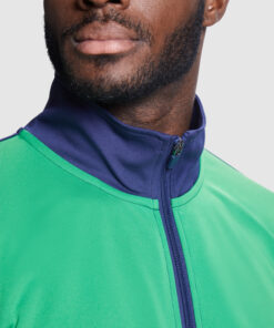 Man wearing green and blue zip-up jacket.