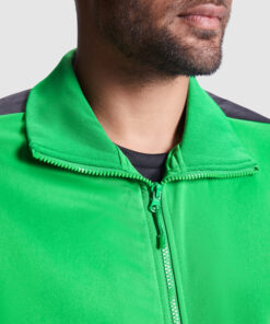 Person wearing bright green jacket with zipper closed.