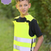 Dreng iført gul refleksvest udendørs